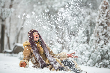 Winter fun, winter leisure, winter holiday. Young winter woman running in winter park. motion
