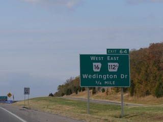 Roadside signs and directions to Wedington Drive along Interstate 49 in Arkansas.