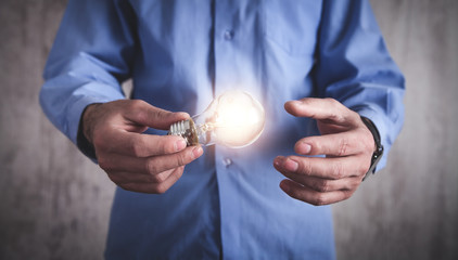 Man holding light bulb. Concept of inspiration and creativity