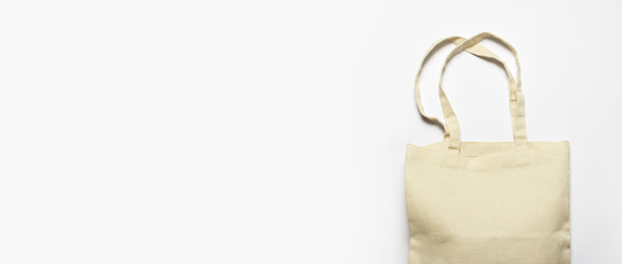 Bright linen bag for shopping on a white background. Eco material. Shopping concept, place for logo. Flat lay, top view