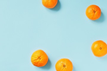 Sweet juicy mandarins on a blue background. Flat lay mockup for Chinese New Year