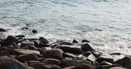 Sand beach water wave of rock and stone at outdoor