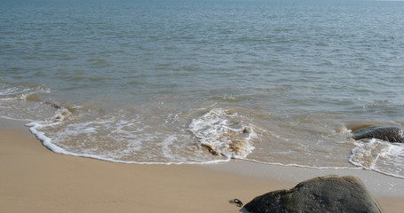 Water wave on sandy beach