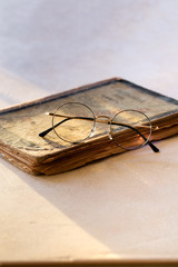 Gold round Glasses on vintage book