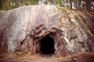 Black hole in rock wall, entrance to the cave in Spro, old mineral mine. Nesodden Norway. Nesoddtangen peninsula. - obrazy, fototapety, plakaty