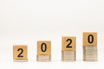 2020 New year, Business, Money, Finance and Saving concept. Closeup of wooden block number on stack of  coins and white background with copy space text.