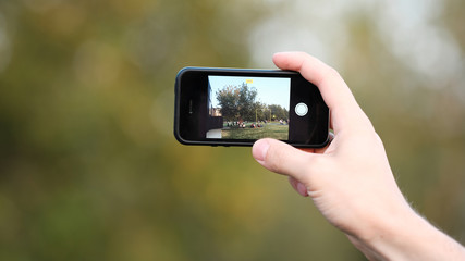 male hand holds the phone. mobile photography.