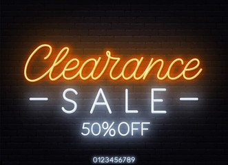 Clearance sale neon sign on dark background.