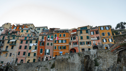 Fototapeta na wymiar View of the beautiful colorful buildings in Chinque Terre, Italy. Cinque Terre old seaside villages on the rugged Italian Riviera coastline