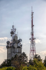 Mobile communication tower with control devices and antennas, transmitters and repeaters for mobile...