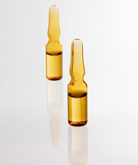 two medical ampoules, gray background