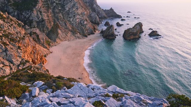 4K sunset footage of Praia da Ursa beach with ocean waves in Sintra, Portugal