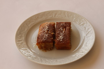 Shambali dessert made with semolina in a white plate.