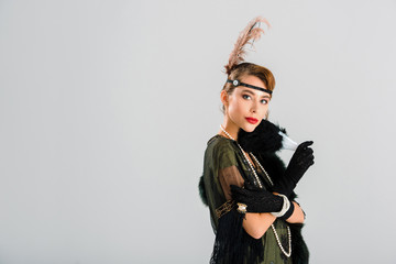 aristocratic woman in black gloves holding feather fan isolated on grey