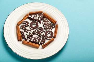 New Year and Christmas chocolate gingerbread cookies in silhouette of 2020. Homemade delicious bakery, sweet family time and traditions.