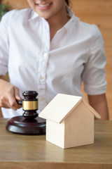 woman hand selling or buying new house; concept of home loan, home finance, home insurance, house mortgage, house buying, real estate agent, family property ownership