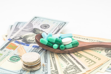 Capsules, tablets, medicines with dollars and COINS, health care, health care concept ideas