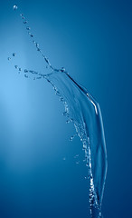 Naklejka na ściany i meble blue color water splash isolated on empty background, studio photo