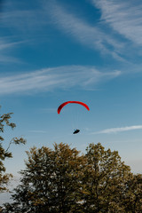 View of a paragliding in the sky. Paraglider flying over in The nature park Zumberak, Croatia