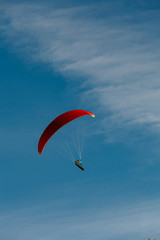 View of a paragliding in the sky. Paraglider flying over in The nature park Zumberak, Croatia