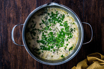 Mushroom Soup with Parsley in Metal Pot.