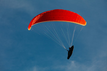 View of a paragliding in the sky. Paraglider flying over in The nature park Zumberak, Croatia