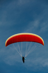 View of a paragliding in the sky. Paraglider flying over in The nature park Zumberak, Croatia
