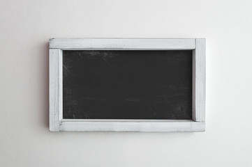 Old blackboard in white wooden frame