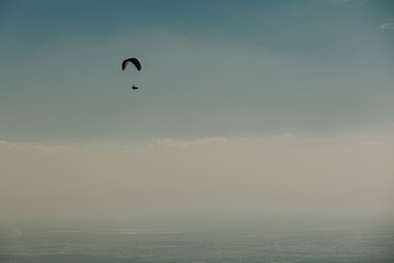 View of a paragliding in the sky. Paraglider flying over in The Nature Park Zumberak, Croatia 