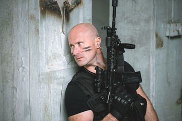Concept photo of special agent man with a rifle. Person with airsoft gun. Thriller film concept.