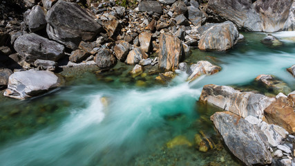 colorful stones and green water of Verzasca river in Ticino Switzerland