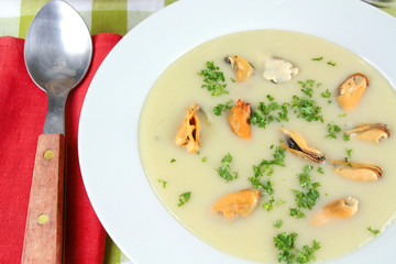 plate of mussel soup on a table