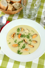 plate of mussel soup on a table