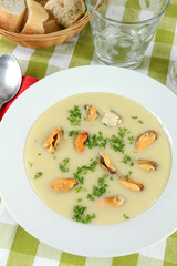 plate of mussel soup on a table