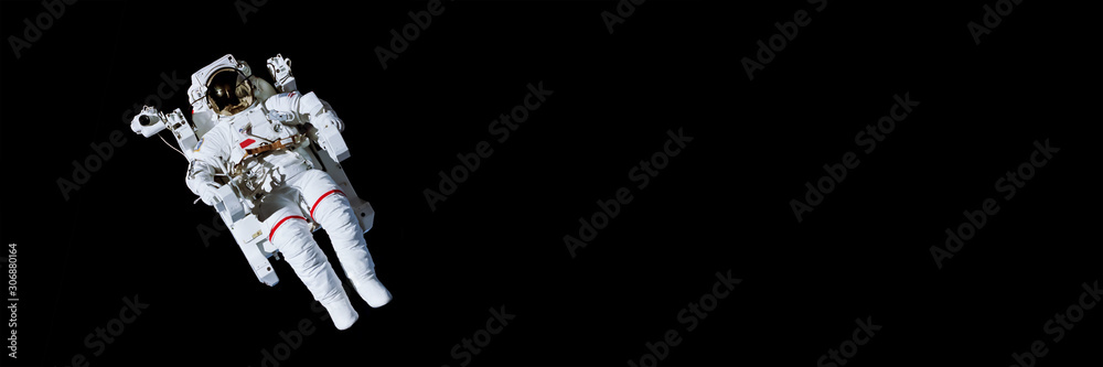 Wall mural astronaut with a jetpack isolated on black panoramic background with copy space - elements of this i