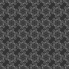 Seamless decorative pattern from stylized flowers. Round shapes on grey background.