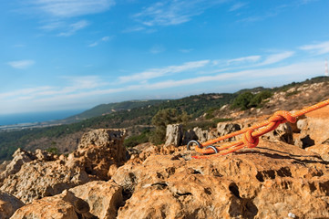 climbing rope tied to a bracket in the mountains