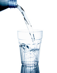 Pouring clean drinking water on a transparent glass. For health concepts. Isolated white background