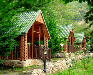 wooden arbors among trees and mountains