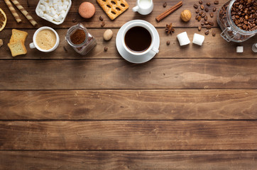 coffee beans with cup at wooden table background