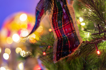 Decorated Christmas tree and creche on a blurred background, and you can see the lights and the warm colors which give it a true spirit and mood