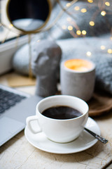 Cozy freelancer's winter work place at home with cup of coffee