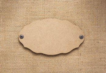 wooden nameplate or wall sign at burlap hessian sacking texture