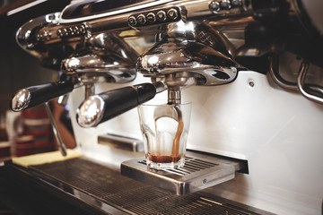 Modern coffee machine making coffee in cafe. Vintage colour tone.