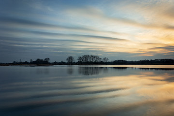 Beautiful evening clouds reflecting in the lake water