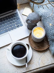 Cozy freelancer's winter work place at home with cup of coffee