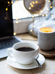 Cozy freelancer's winter work place at home with cup of coffee