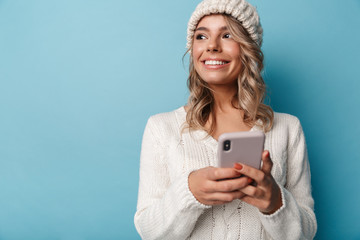 Portrait of caucasian happy woman smiling and using cellphone