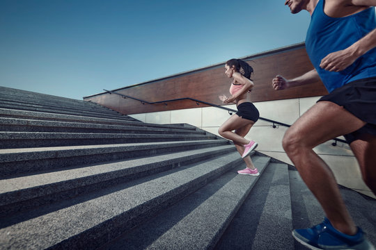 Athletic Young People Jogging On A Stairs.