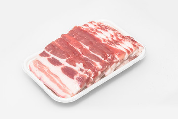 Sliced pork belly on a white background
